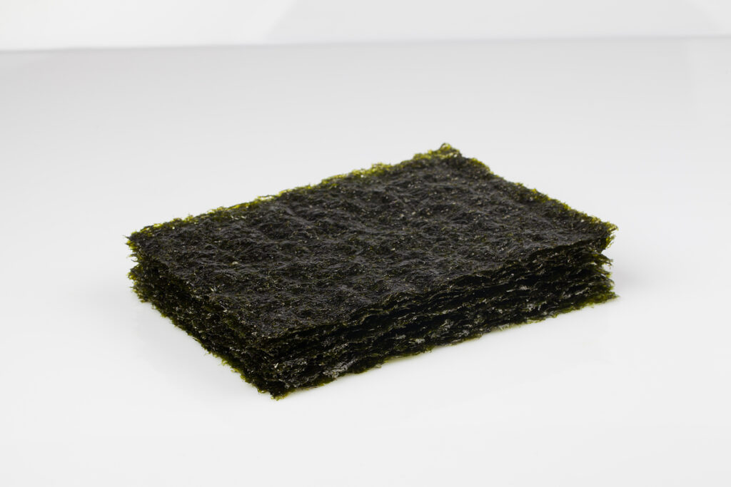 Dried gim Korean seaweed stack with characteristic purple-black color rich in iodine omega-3 and complete protein for thyroid health.