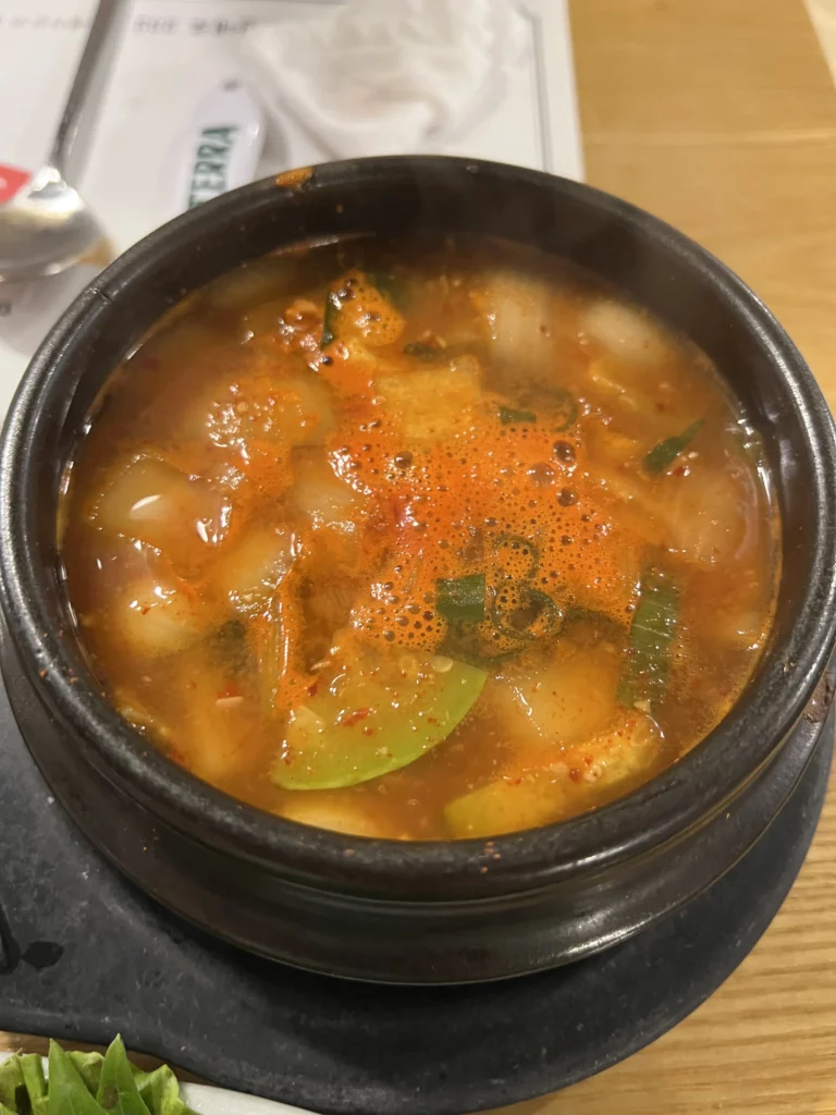Hot doenjang-jjigae soybean paste stew with tofu and vegetables served as a finishing dish after Korean BBQ at Mapo Charcoal Pork Ribs.