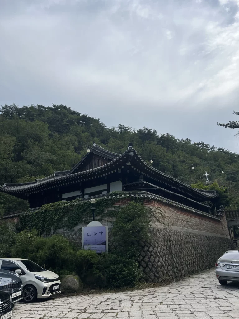 Traditional Korean hanok architecture at Seonungak cafe with curved rooflines and ivy-covered stone walls at Bukhansan Mountain Seoul.