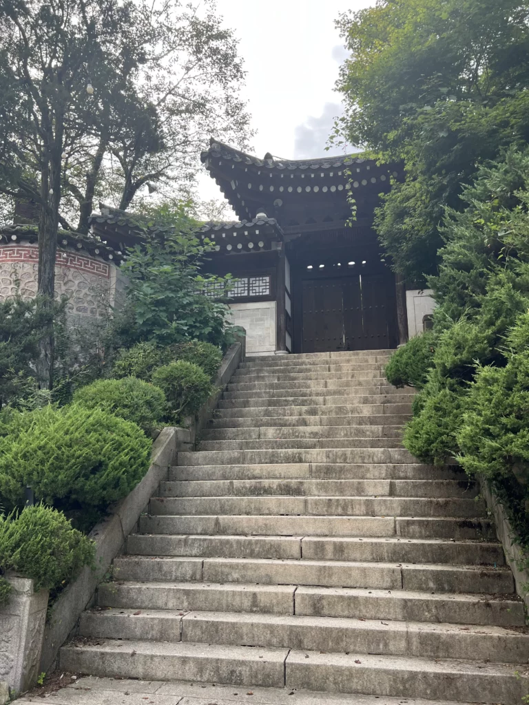Stone steps leading to the main entrance of Seonungak traditional hanok cafe with curved roofline architecture at Bukhansan Mountain Seoul.