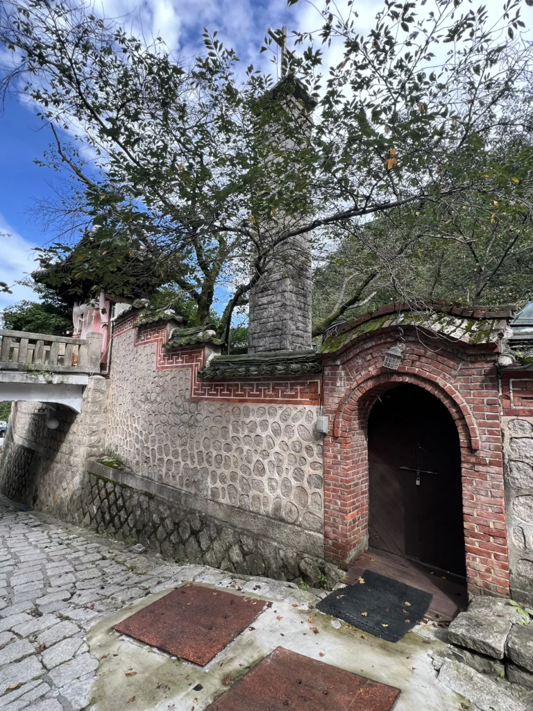 Red brick archway entrance with traditional stone walls at Seonungak historic hanok cafe in Bukhansan National Park Seoul.
