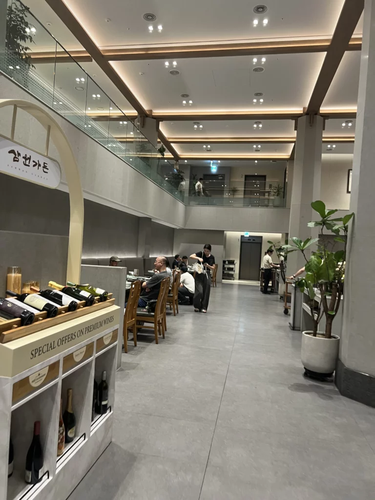 Upscale entrance lobby at Samwon Garden restaurant in Gangnam Seoul featuring wine display and contemporary architecture for Michelin Guide featured Hanwoo beef dining.
