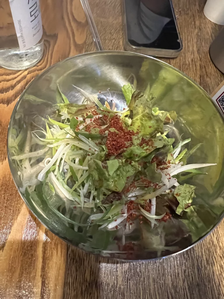 Fresh lettuce and pajeori green onion salad with chili powder seasoning at Seokam Saeng Sogeum-gui Korean BBQ restaurant Seoul.