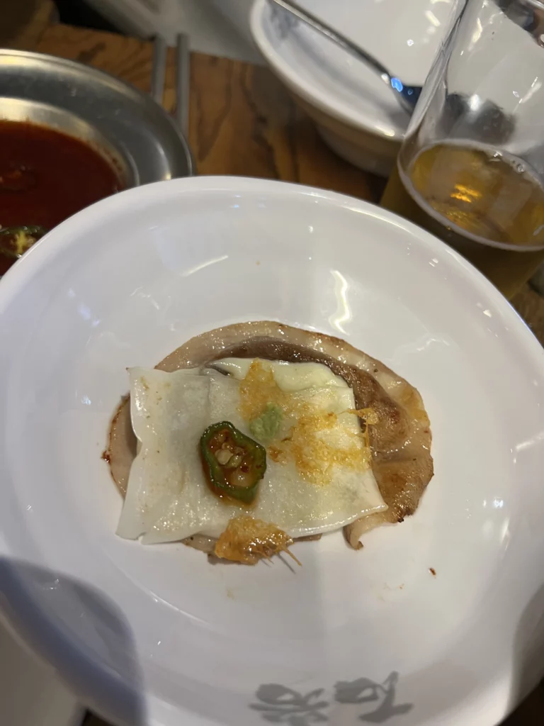 Korean lettuce wrap ssam with grilled samgyeopsal pork belly, radish, jalapeño and sesame oil salt at Seokam restaurant.