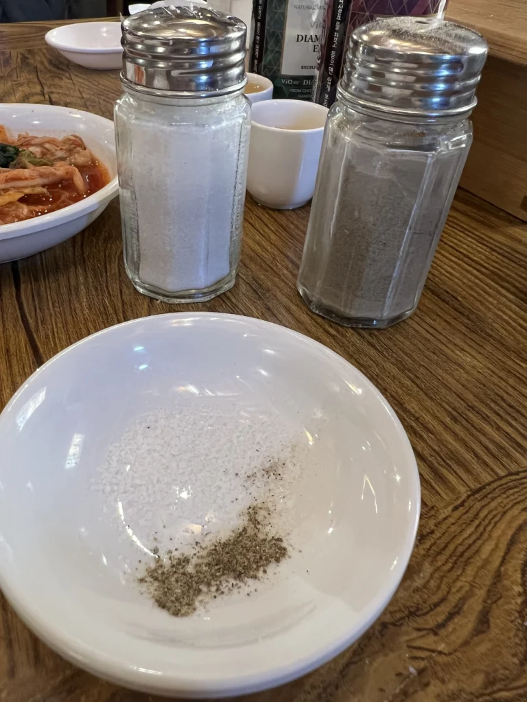 Salt and pepper seasoning mixture for Tosokchon samgyetang, traditional condiments for Korean ginseng chicken soup at Seoul's legendary restaurant.