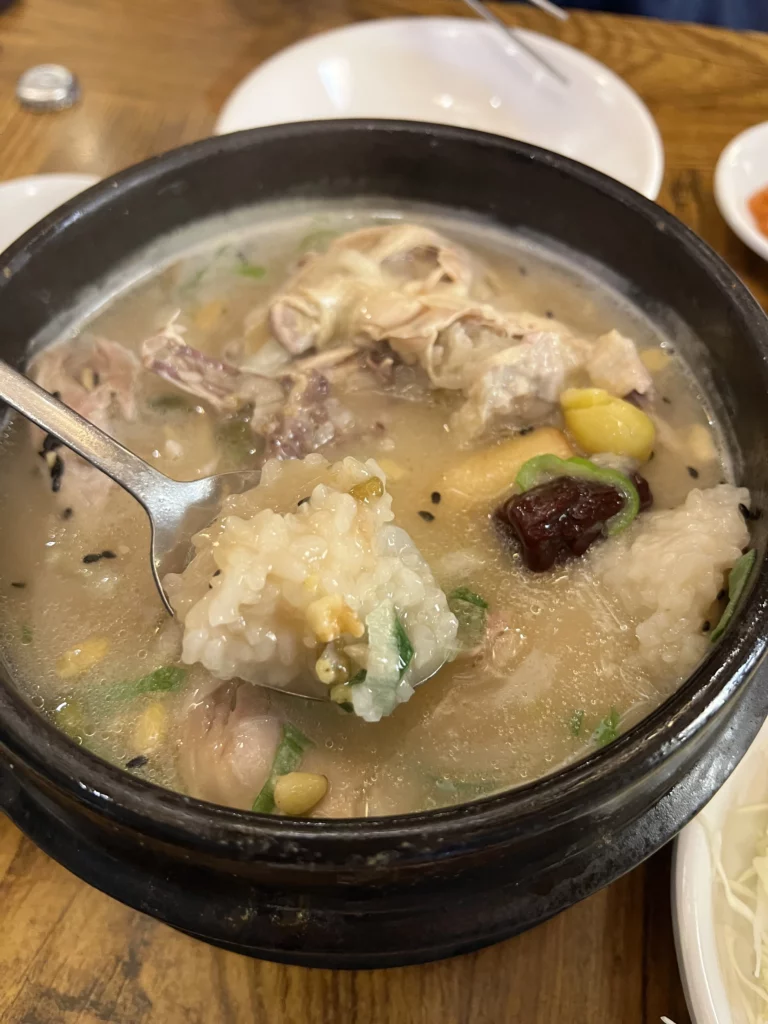 Glutinous rice stuffing from Tosokchon samgyetang with ginseng, jujube, and tender chicken in signature pine nut enriched broth, Seoul's traditional Korean wellness soup.