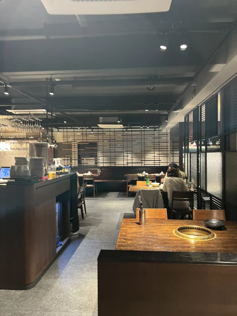 Modern dining interior with charcoal grill tables at Bongpiyang Michelin Bib Gourmand Korean BBQ restaurant in Gangnam Seoul.