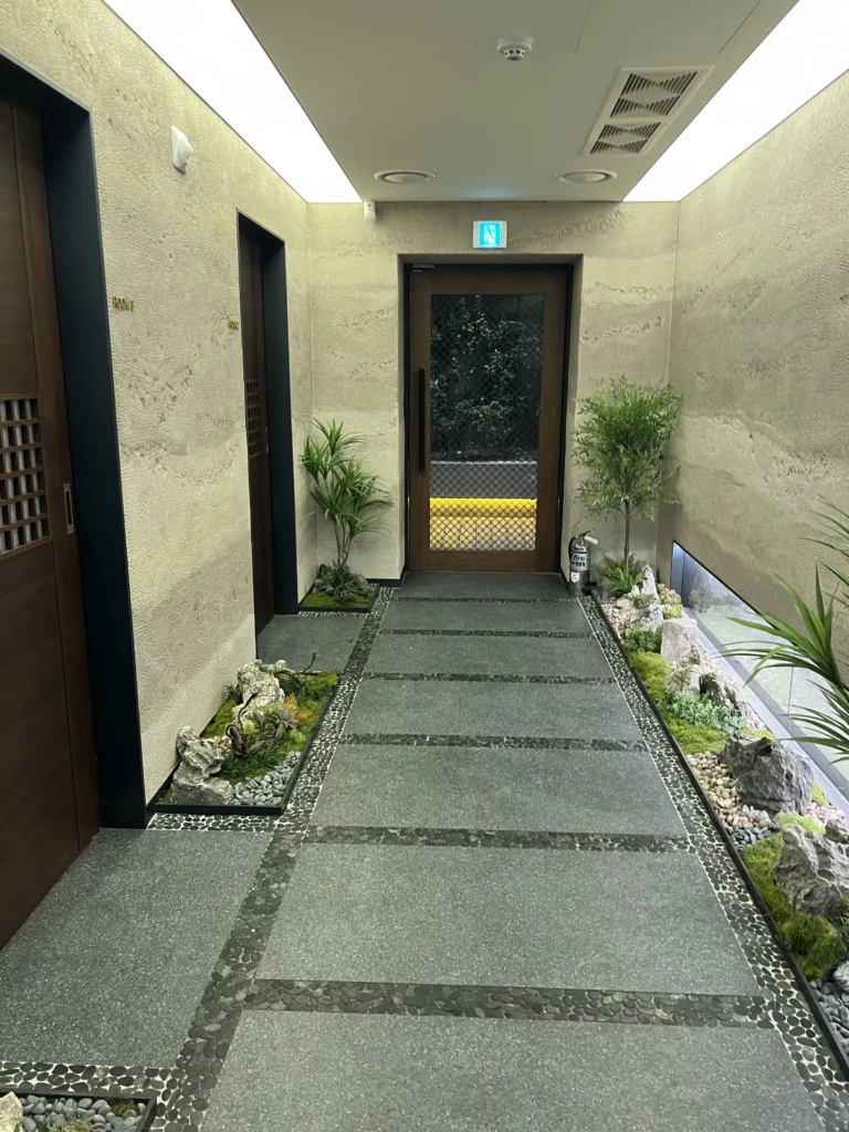 Elegant entrance hallway with stone walls and garden decoration at Bongpiyang Michelin Bib Gourmand Korean BBQ restaurant in Sinsa-dong Gangnam.