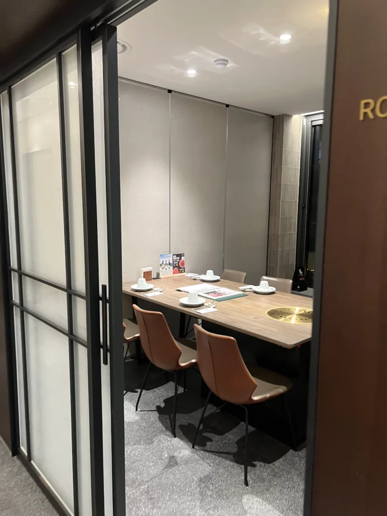 Elegant entrance hallway with stone walls and garden decoration at Bongpiyang Michelin Bib Gourmand Korean BBQ restaurant in Sinsa-dong Gangnam.