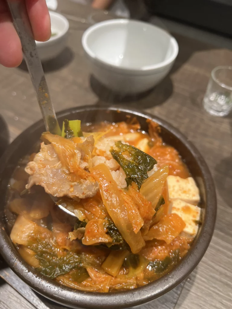 Traditional Korean kimchi side dish served with pork ribs at Bongpiyang Michelin-recommended BBQ restaurant in Seoul.