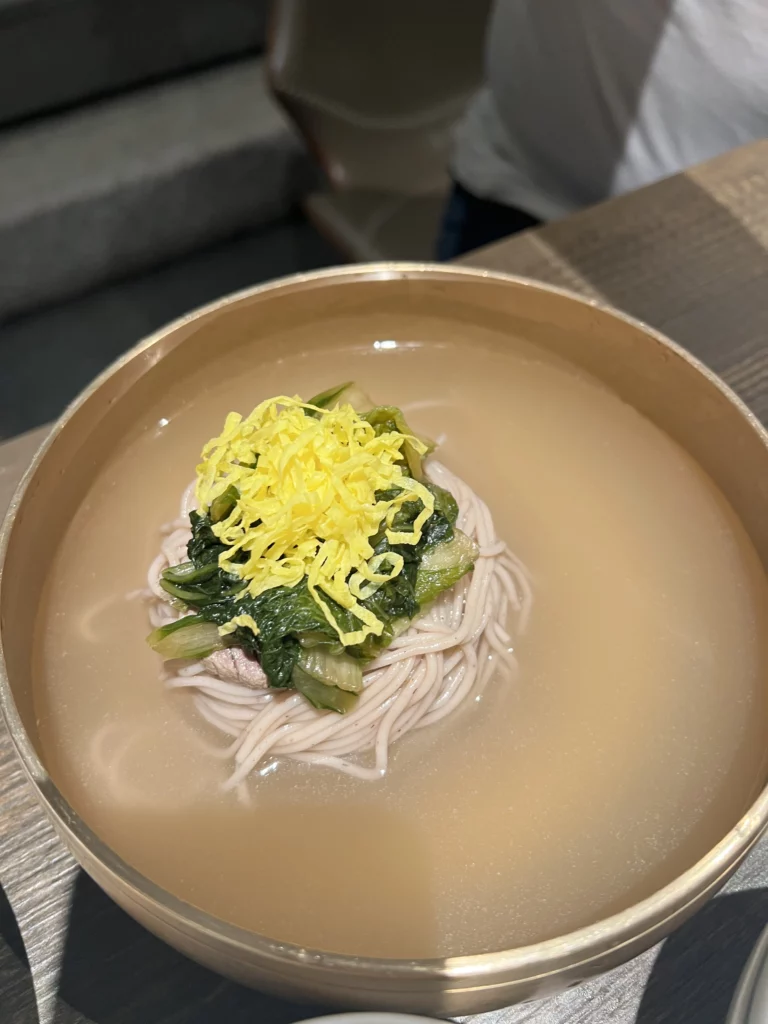 Pyongyang-style cold noodles naengmyeon in beef broth with egg garnish at Bongpiyang Korean BBQ restaurant Seoul.