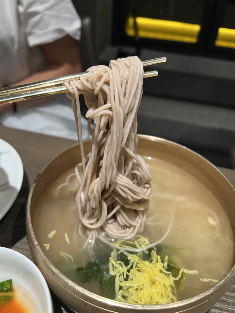 Pyongyang-style naengmyeon cold noodles served in beef broth at Bongpiyang Michelin Bib Gourmand Korean BBQ restaurant Seoul.