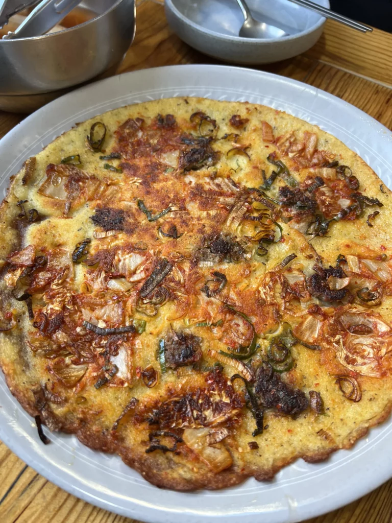 Nokdu-bindaetteok Korean mung bean pancake with vegetables and kimchi at Nunnamu-jip Bukchon restaurant in Seoul Korea.
