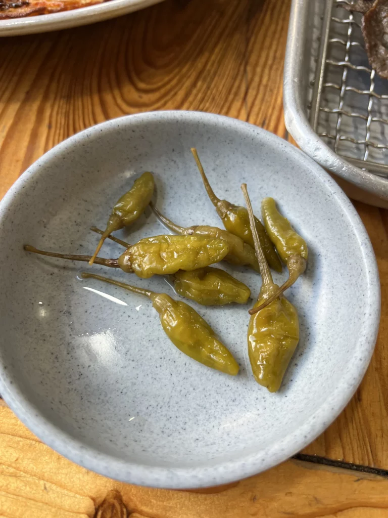 Pickled Korean peppers banchan side dish served at Nunnamu-jip Bukchon restaurant with traditional bulgogi meal in Seoul.