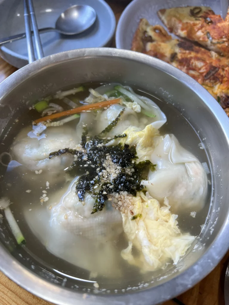 Mandu-guk Korean dumpling soup with seaweed and egg garnish served at Nunnamu-jip Bukchon restaurant in Seoul.
