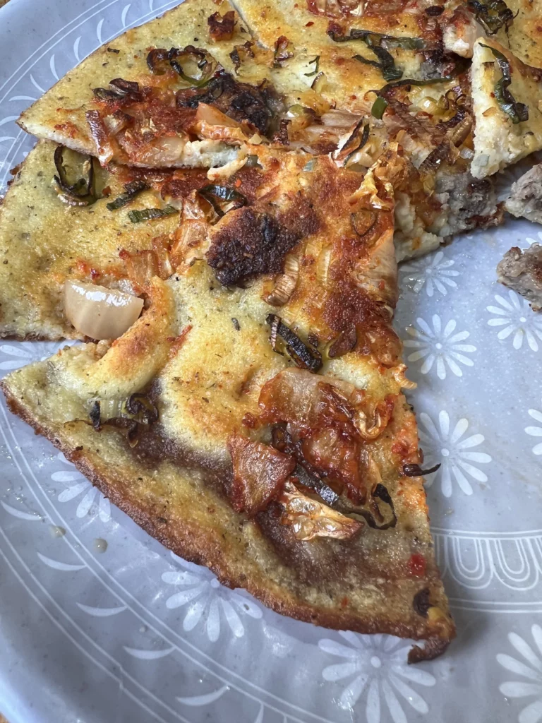 Crispy sliced nokdu-bindaetteok Korean mung bean pancake with kimchi and vegetables served at Nunnamu-jip Bukchon restaurant Seoul Korea.