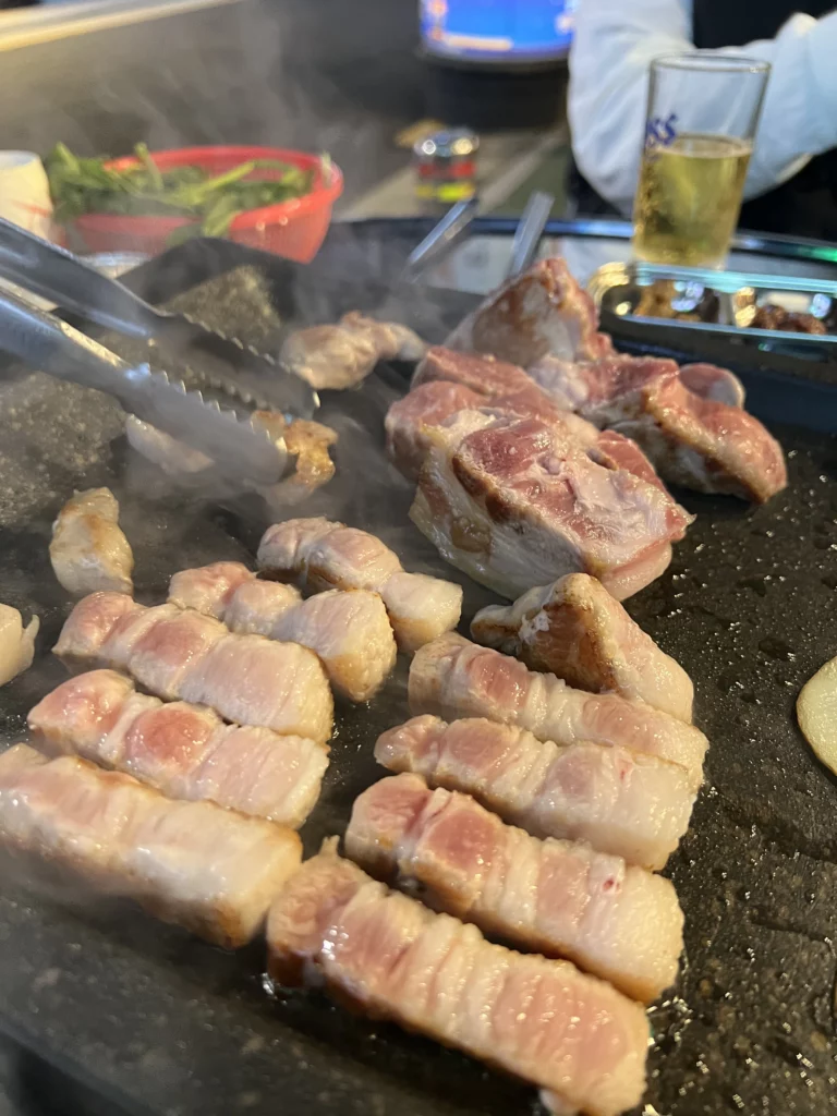 Tableside grilling of 22-day aged samgyeopsal cut into bite-sized pieces at Gimsukseoung Korean BBQ restaurant in Seoul.