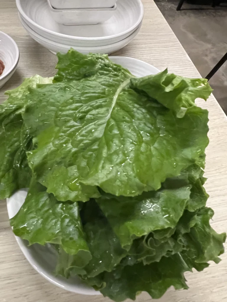 Fresh green lettuce leaves for wrapping samgyeopsal at Moosik authentic Korean BBQ restaurant in Sinsa-dong Gangnam Seoul.