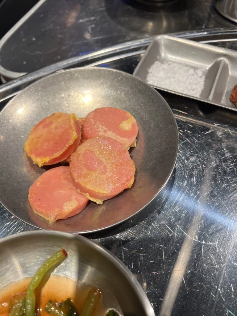Sliced ham served as banchan side dish at Moosik samgyeopsal restaurant table in Sinsa-dong Gangnam Seoul Korea.