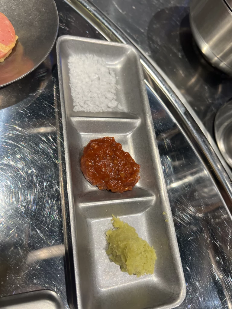 Traditional Korean BBQ condiments including salt gochujang sauce and mustard served at Moosik samgyeopsal restaurant in Sinsa-dong Gangnam Seoul.