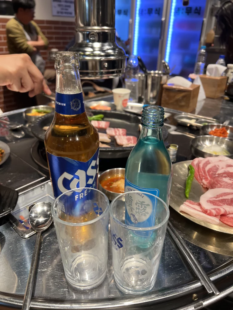 Cass beer and soju bottles with glasses served for samgyeopsal meal at Moosik Korean BBQ restaurant in Sinsa-dong Gangnam Seoul.