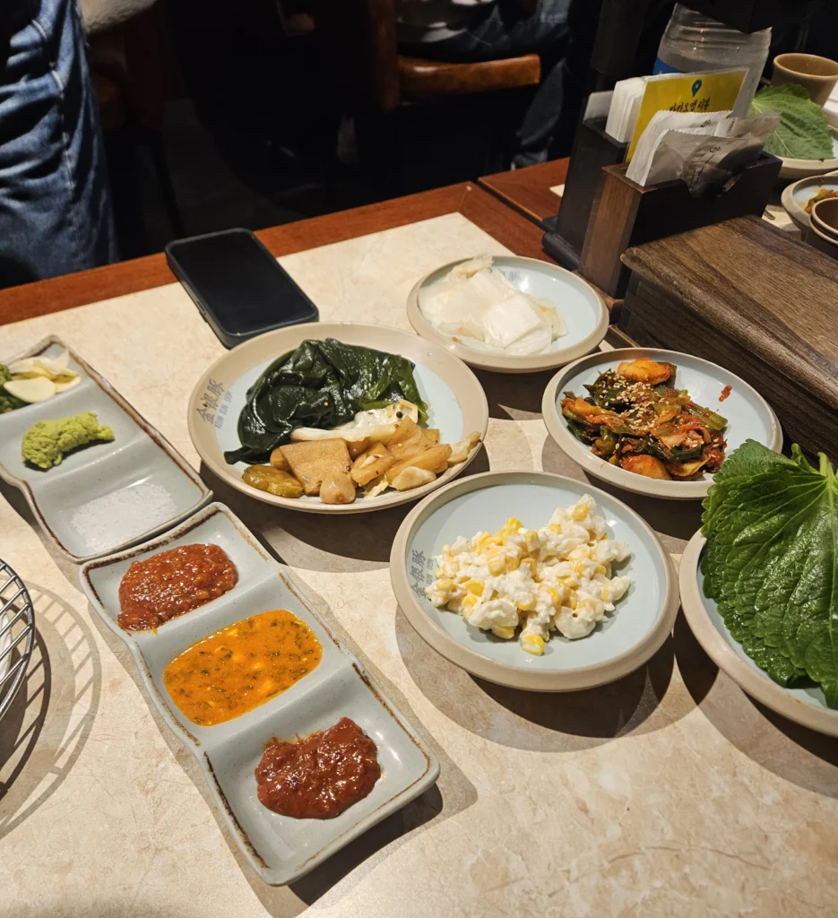 Various sauce and side dishes prepared to eat with samgyeopsal K-BBQ at Keum Eun Don.