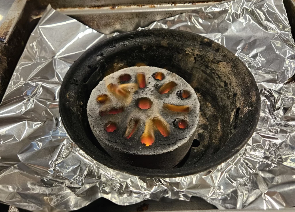 Glowing charcoal fire used for authentic beef korean bbq grilling at a Korean restaurant.