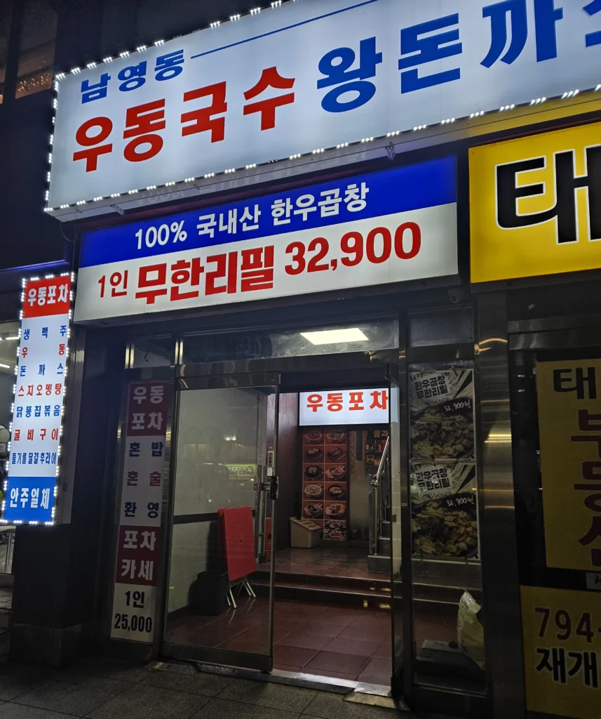 Exterior of a Korean restaurant specializing in gopchang, featuring bright signage advertising all-you-can-eat Korean beef intestines.