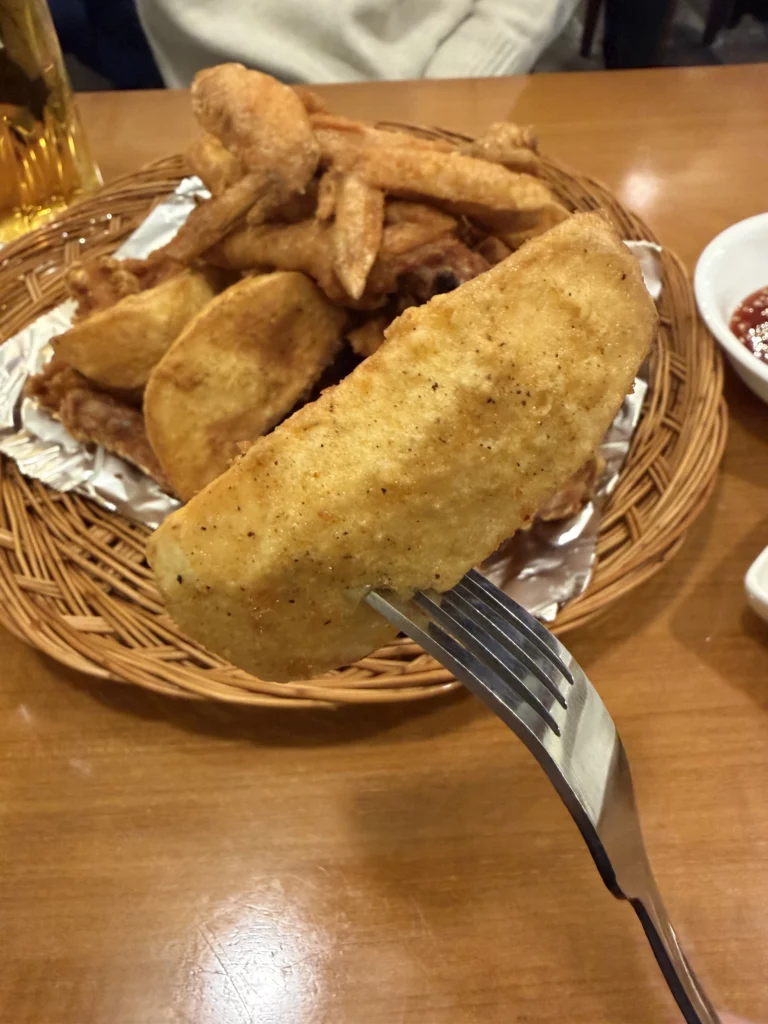 Gyeyeolsa famous thick-cut potato wedges with crispy glutinous rice flour batter served alongside Korean fried chicken in Seoul Buam-dong.