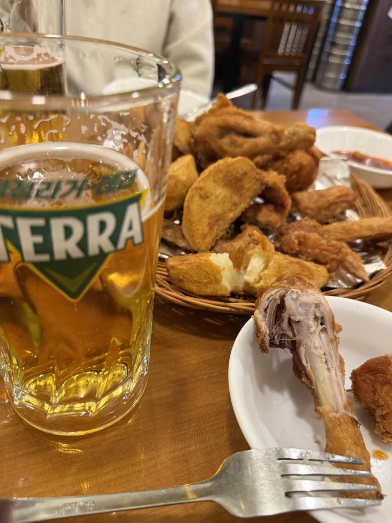 Gyeyeolsa chimaek pairing with Terra beer and crispy Korean fried chicken at Seoul Buam-dong restaurant specializing in traditional chicken and beer culture.