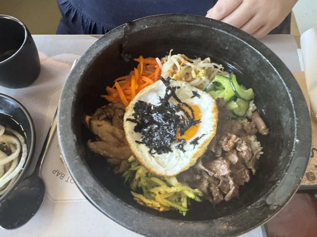 Traditional Korean hot stone pot bibimbap with fried egg, vegetables, and beef at Gamsa Korean BBQ Melbourne.