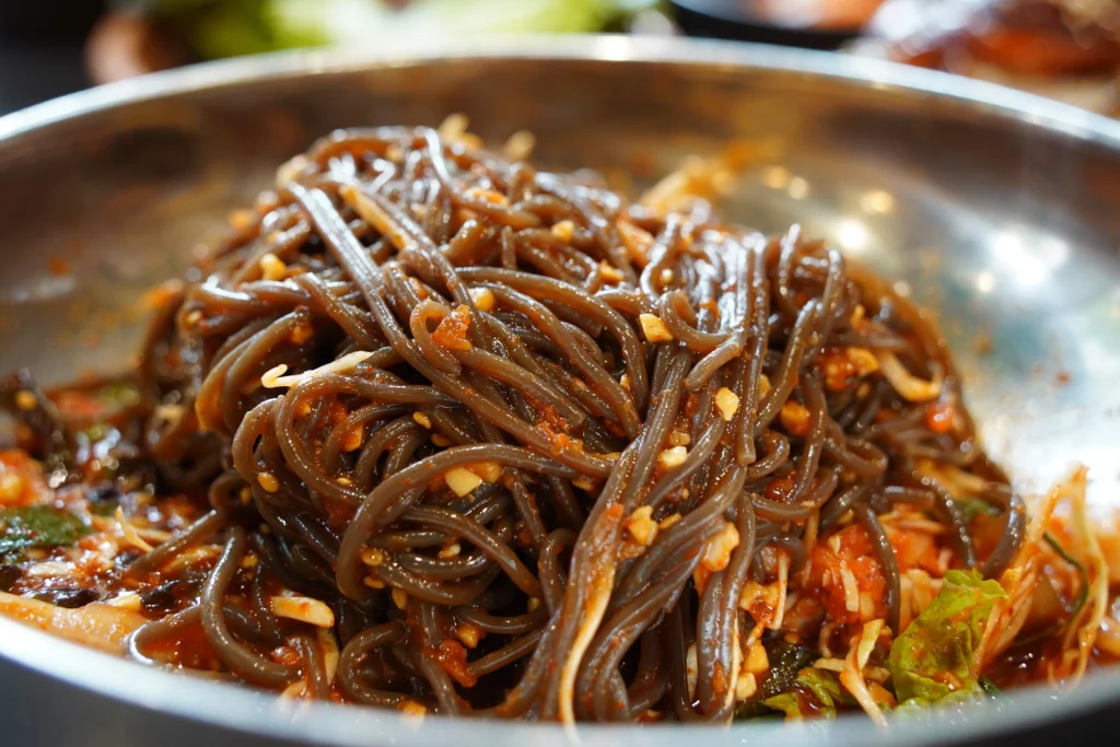 Makguksu cold buckwheat noodles served as a refreshing side dish to complement the spicy charcoal grilled chicken galbi at Tongnamujip restaurant in Chuncheon