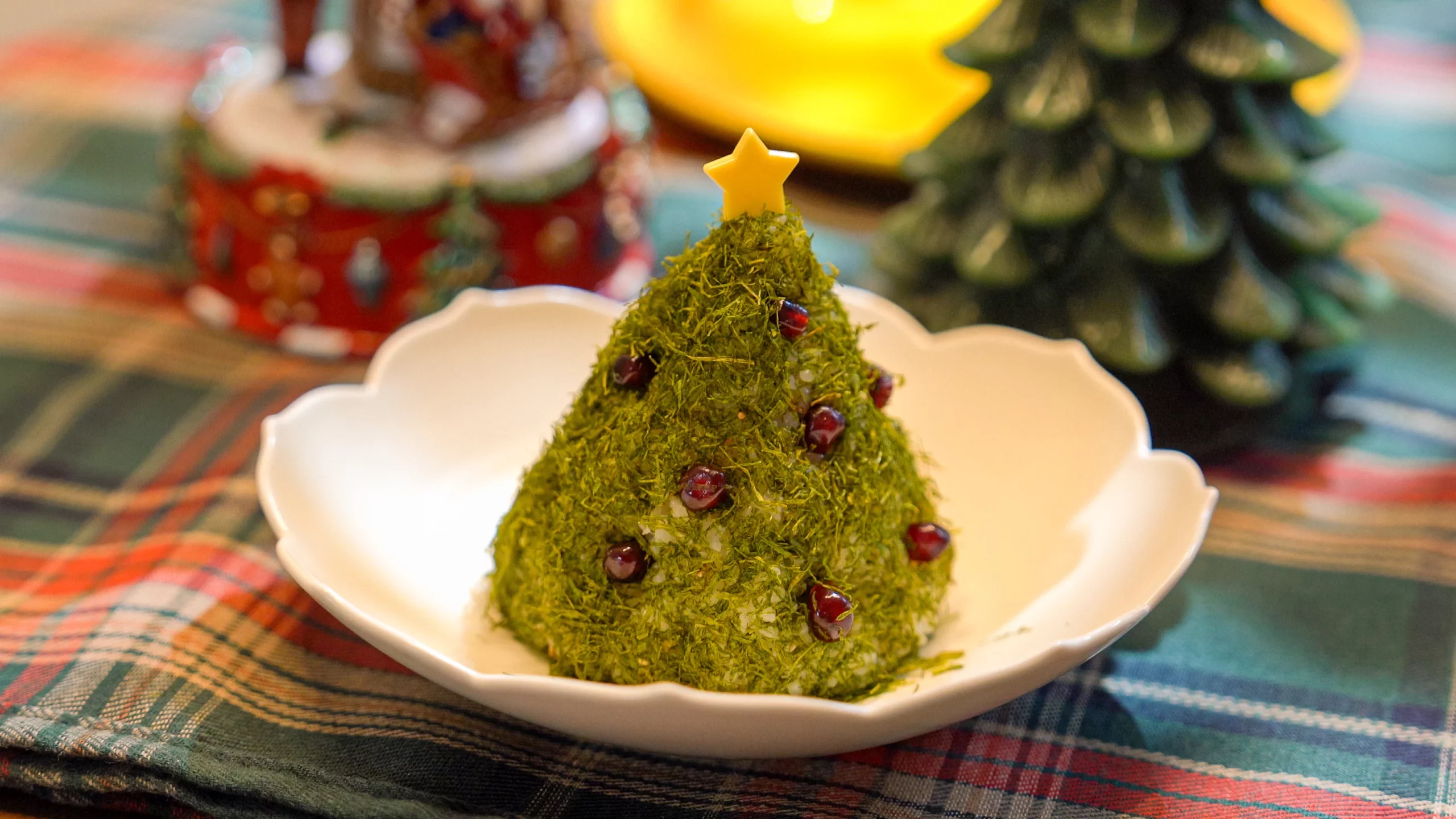 Finished gamtae Christmas tree rice ball served on a white plate as festive holiday dish.