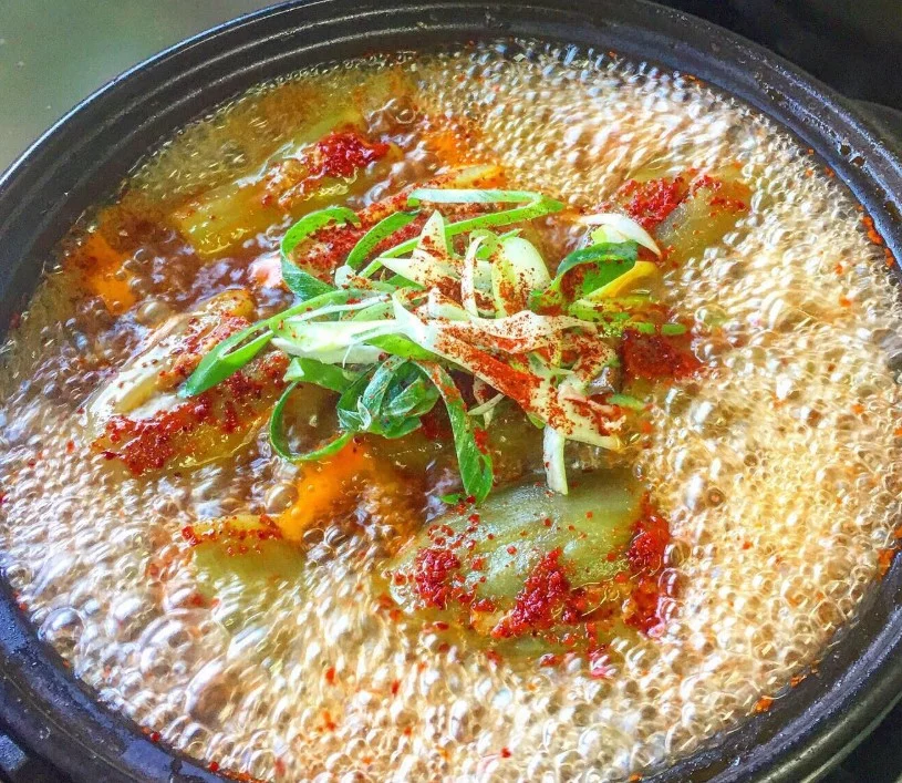 Steamed eggplant in golden broth topped with red chili powder and scallions at Sosohan Scenery Korean restaurant.