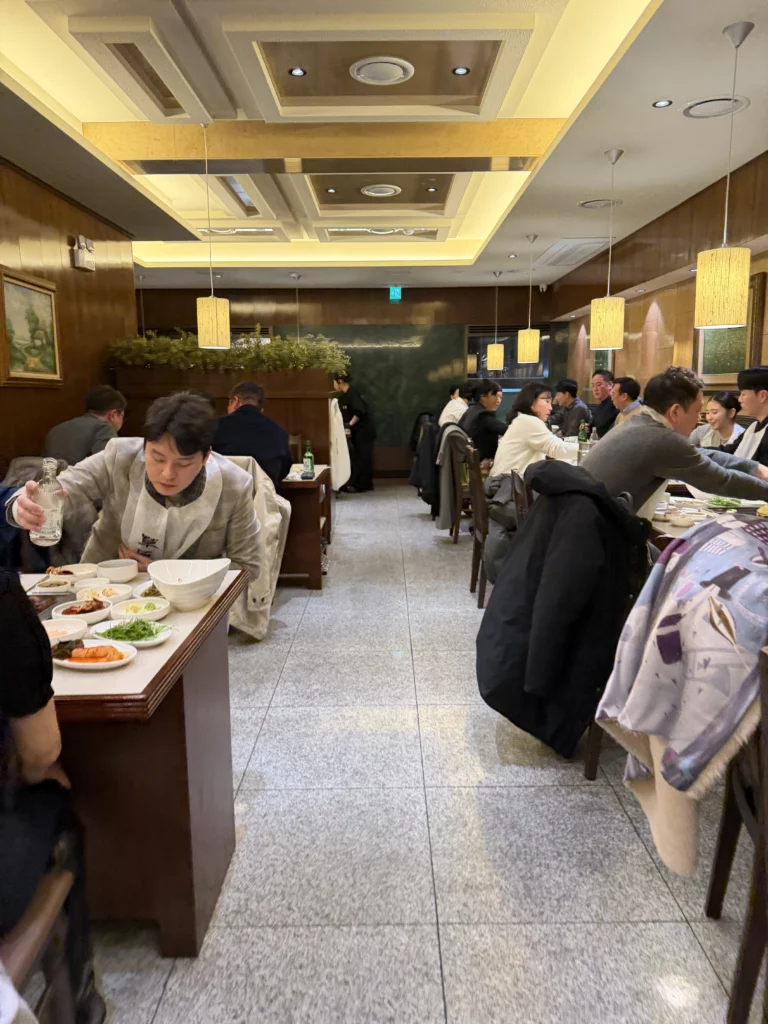 Chowon Korean BBQ restaurant interior in Gangnam Seoul with diners enjoying marinated sirloin jumulleok and beef tongue at traditional tables.