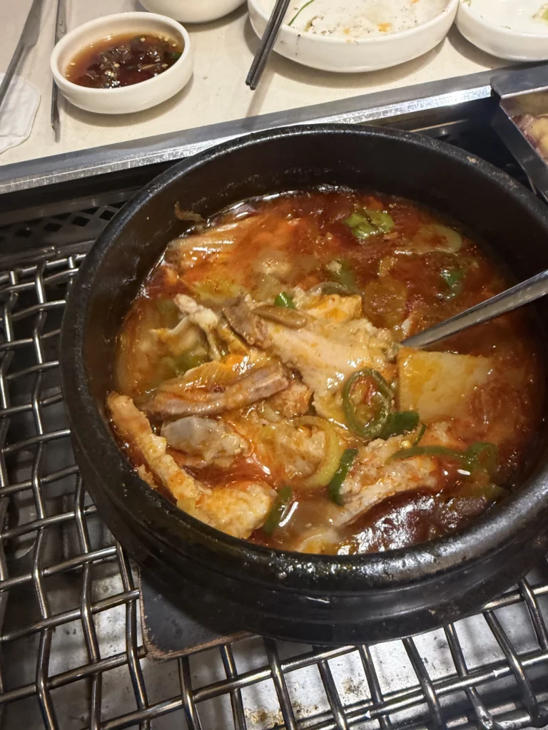 Gopnaejangtang beef tripe soup with tender intestines and scallions in spicy broth served in traditional stone pot at Chowon Korean BBQ Gangnam Seoul.