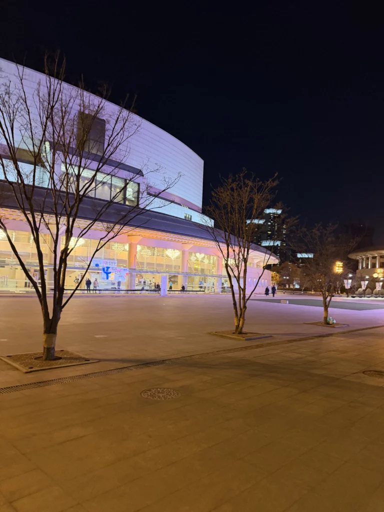 Seoul Arts Center evening view with illuminated modern architecture and plaza near Dam Restaurant, premier Korean cultural complex in Seocho-gu for hanjeongsik dining and performing arts.