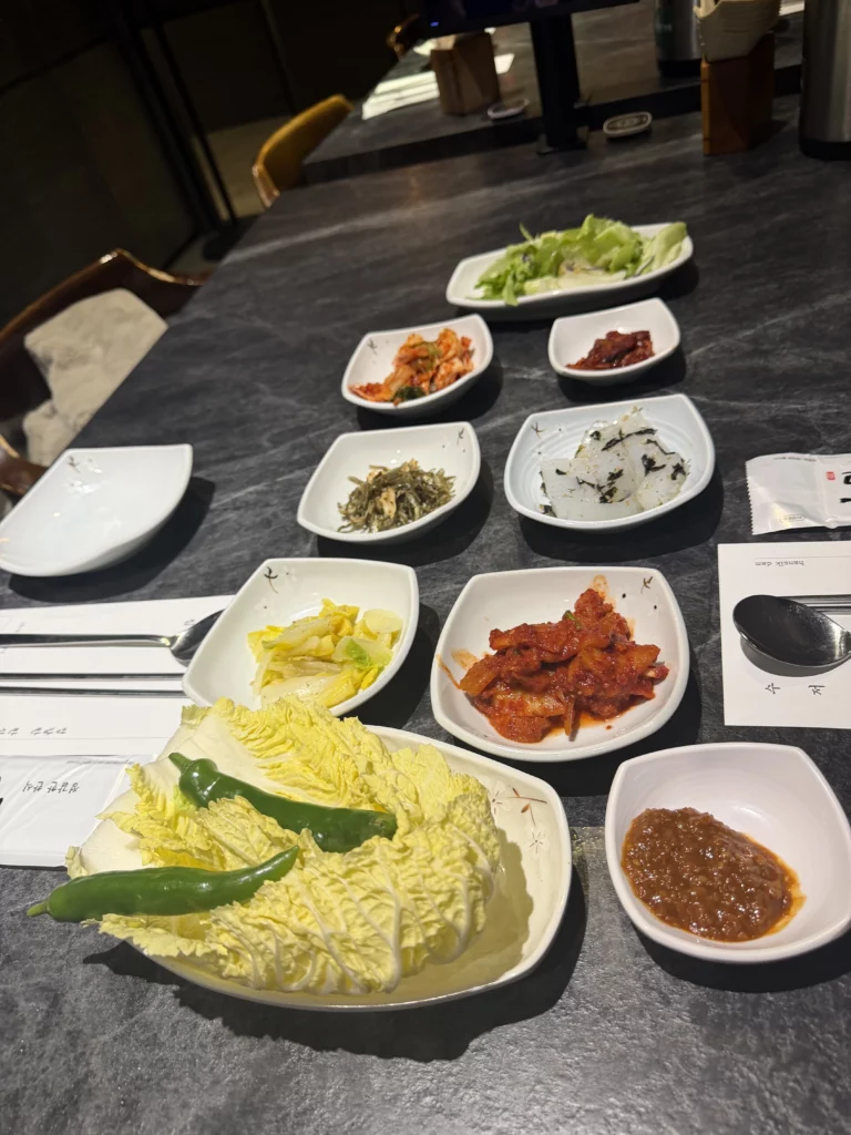 Korean banchan side dishes spread with napa cabbage, kimchi, pickled vegetables, and fermented condiments for Dam Restaurant hanjeongsik hansangcharim meal at Seoul Arts Center.