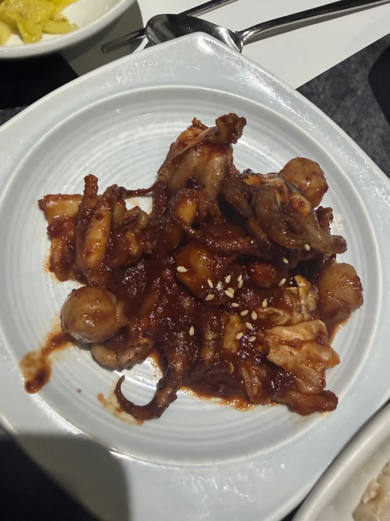 Jeyuk bokkeum spicy stir-fried pork with sesame seeds in sweet-savory gochujang sauce, traditional Korean banchan dish from Dam Restaurant hanjeongsik hansangcharim meal.