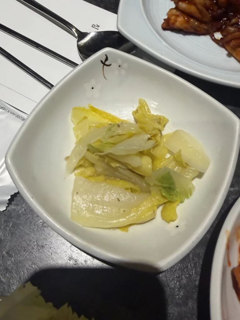 Pickled napa cabbage or white kimchi banchan with light seasoning, traditional Korean fermented side dish from Dam Restaurant hanjeongsik meal at Seoul Arts Center.