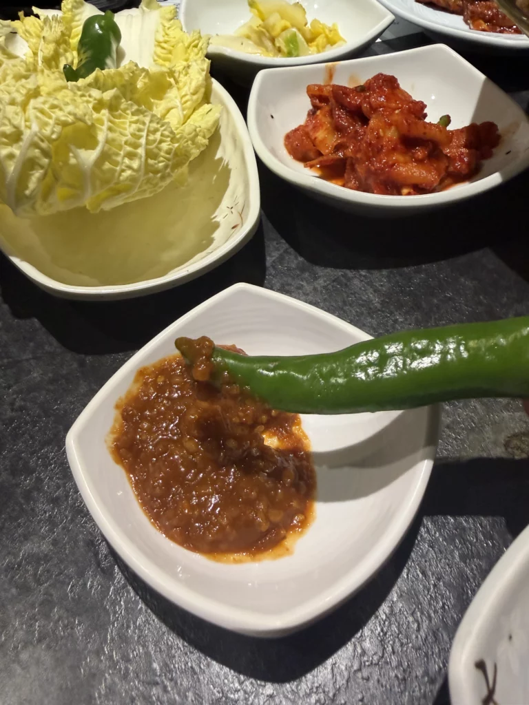 Ssamjang fermented paste with fresh green pepper and napa cabbage for Korean ssam wraps, traditional banchan condiments from Dam Restaurant hanjeongsik at Seoul Arts Center.