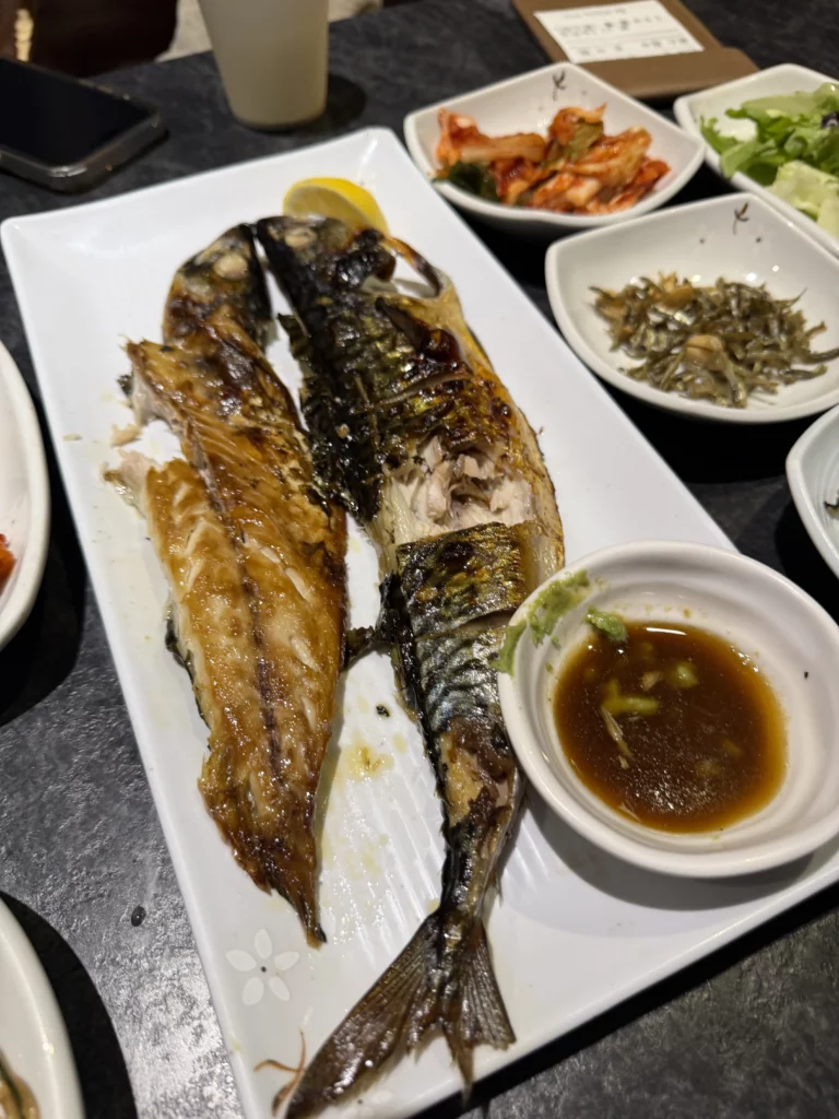 Grilled mackerel godeung-eo gui with soy dipping sauce and lemon, traditional Korean seafood dish served at Dam Restaurant hanjeongsik meal at Seoul Arts Center.