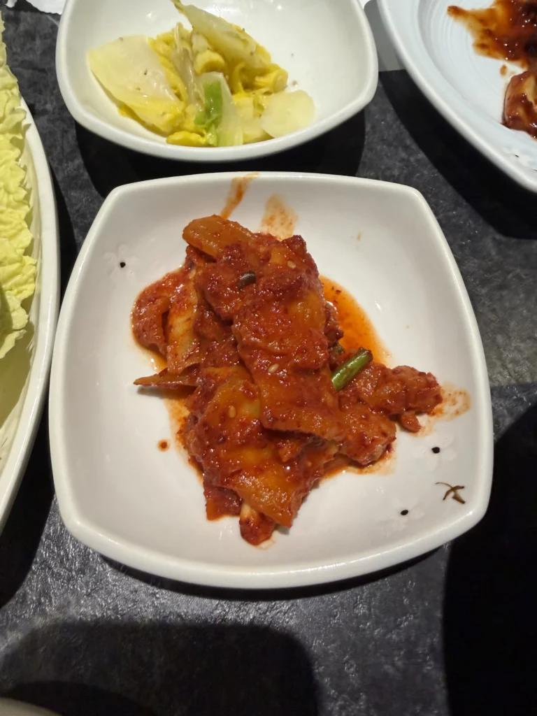 Spicy radish kimchi kkakdugi with gochugaru red pepper seasoning, traditional Korean fermented banchan side dish from Dam Restaurant hanjeongsik meal at Seoul Arts Center.