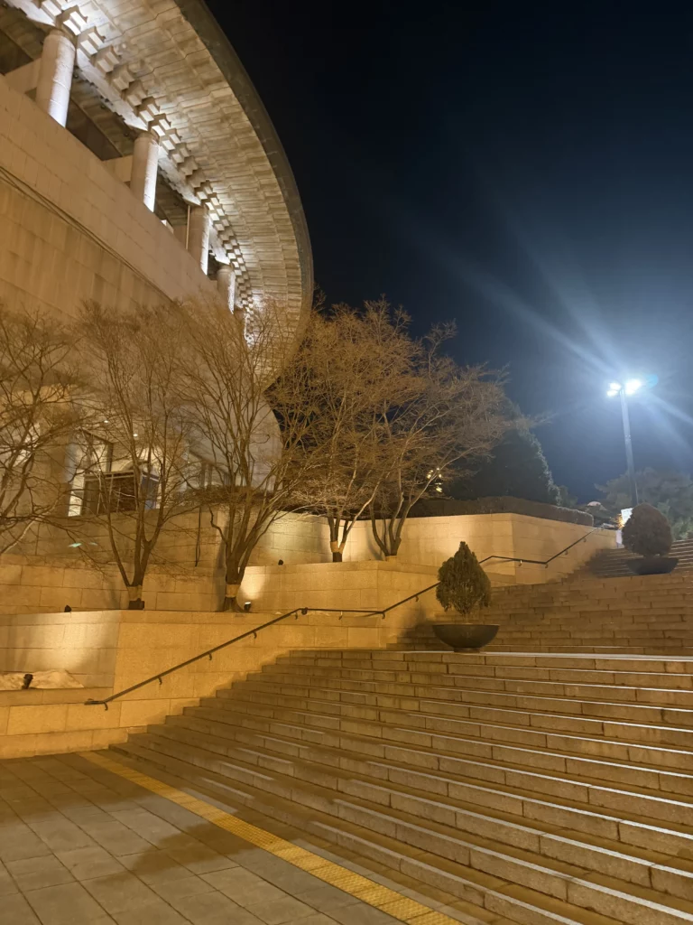 Seoul Arts Center Opera House exterior steps and illuminated architecture at night, premier cultural venue in Seocho-gu Seoul home to Dam Restaurant for traditional Korean hanjeongsik dining.