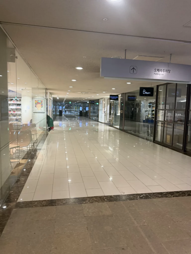 Seoul Arts Center interior corridor with Opera House directional signage, modern hallway leading to Dam Restaurant at Calligraphy Museum for traditional Korean hanjeongsik dining in Seocho-gu Seoul.