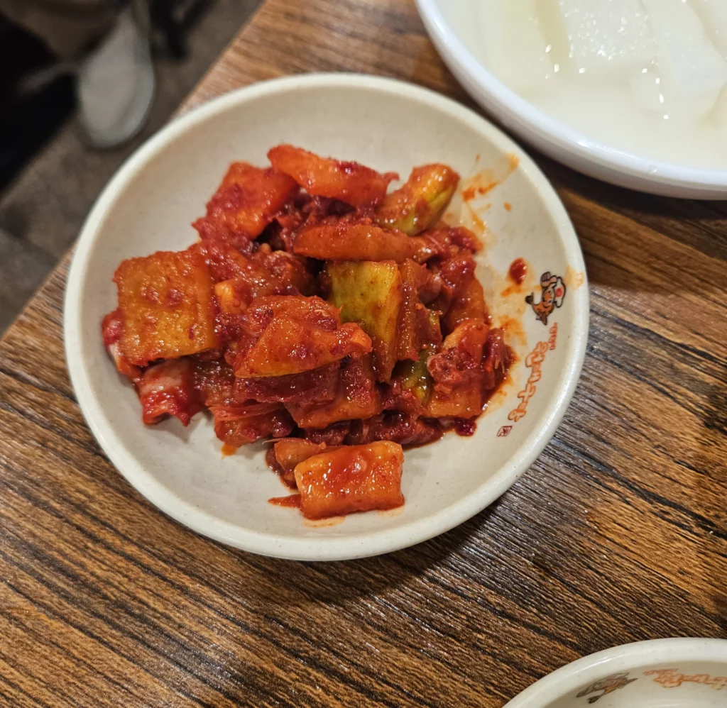 Korean spicy radish kimchi side dish served at Won Daegu-tang restaurant alongside Won Daegu-tang Cod-fish Hot Pot.