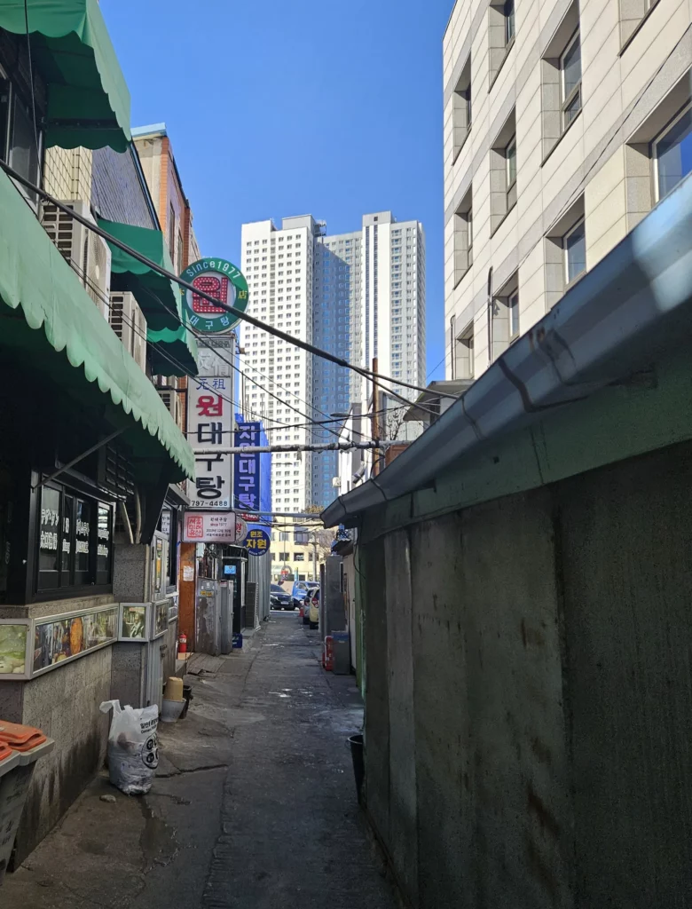 Narrow alley in Seoul leading to Won Daegu-tang restaurant, a historic spot famous for Won Daegu-tang Cod-fish Hot Pot since 1977.