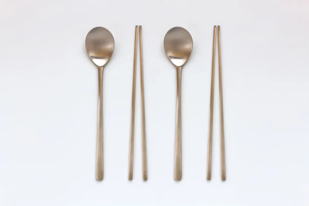 Traditional Korean metal sujeo set with spoons and chopsticks used for eating bunsik dishes at Durumi Bunsik.
