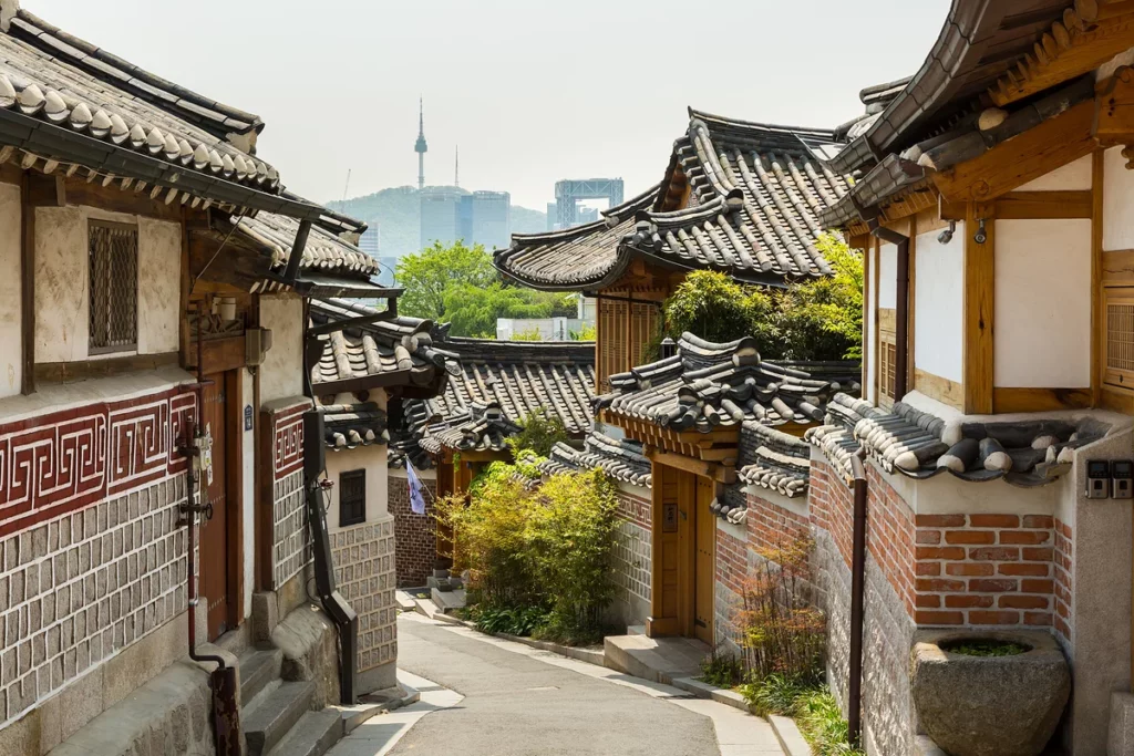 Traditional hanok rooftops in Bukchon Hanok Village with Namsan Tower in the background, located near Bukchon Son Mandu.