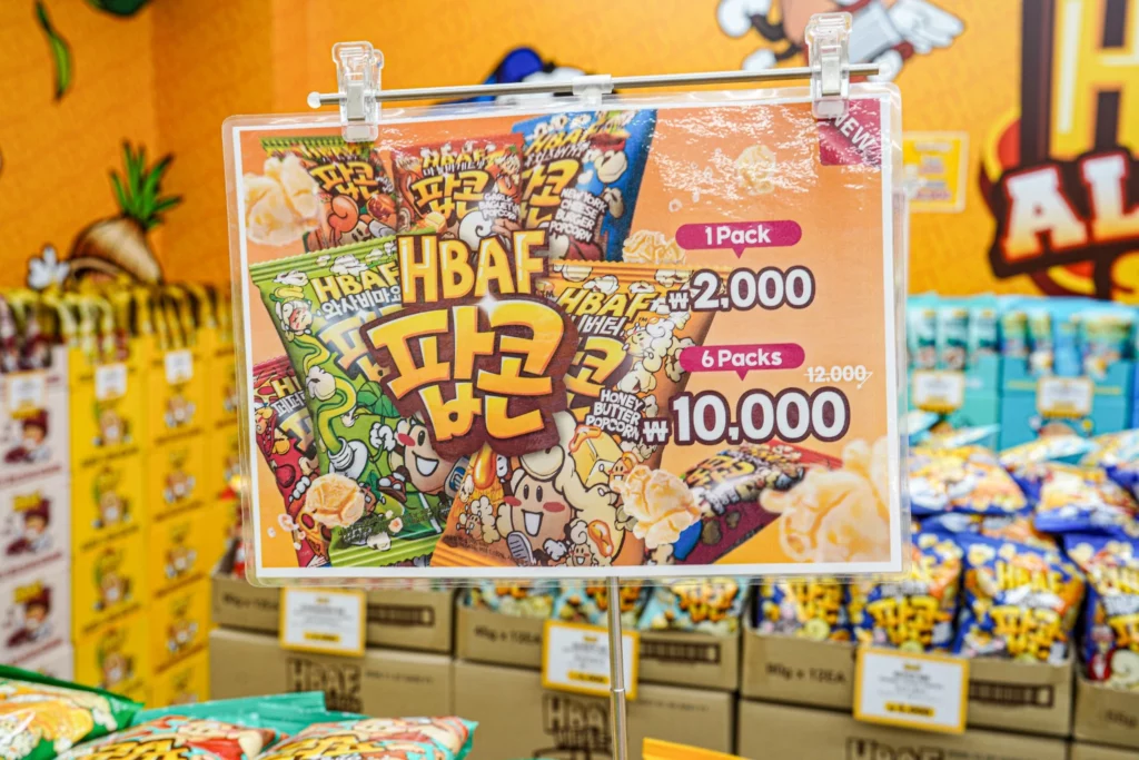 HBAF almond product display at Gwangjang Market showing multiple flavor options available for Korean snack souvenirs.